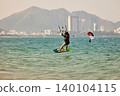 Nha Trang, Khanh Hoa, Vietnam - April 6, 2026: Kitesurfer Performing Jump Above Waves in Nha Trang 140104115