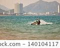 Nha Trang, Khanh Hoa - Vietnam - April 6, 2026: Kitesurfer Cutting Through Waves in Open Sea 140104117