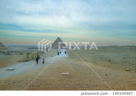Tourists Walking Towards Pyramids of Giza in Cairo Egypt Tourists Walking Towards Pyramids of Giza in Cairo Egypt 140104987