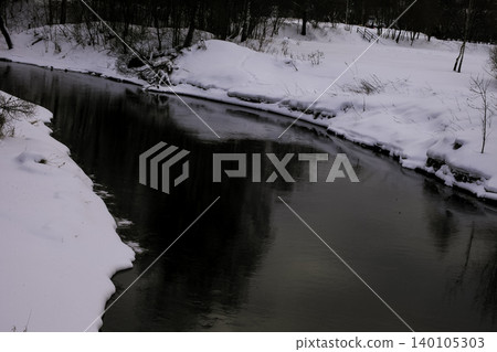 Serene Winter Landscape of a Sinuous River Flowing through a Snowy Forest Serene Winter Landscape of a Sinuous River Flowing through a Snowy Forest 140105303