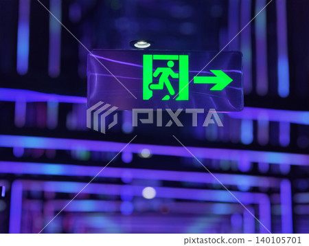 Glowing green emergency exit sign in a futuristic neon-lit interior with vibrant purple and blue lights. Glowing green emergency exit sign in a futuristic neon-lit interior with vibrant purple and blue lights. 140105701