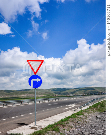 Traffic sign indicates mandatory right turn on open highway Traffic sign indicates mandatory right turn on open highway 140105711