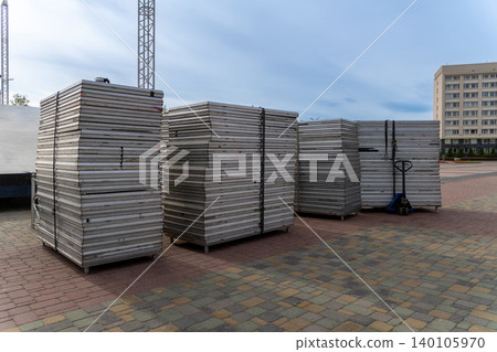 Stacks of metal panels on pallets in outdoor construction site Stacks of metal panels on pallets in outdoor construction site 140105970
