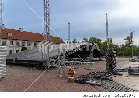 Stacks of portable metal stage decks and trusses Stacks of portable metal stage decks and trusses 140105973