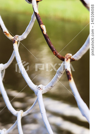 Rusty chain link fence showing corrosion texture detail Rusty chain link fence showing corrosion texture detail 140106088