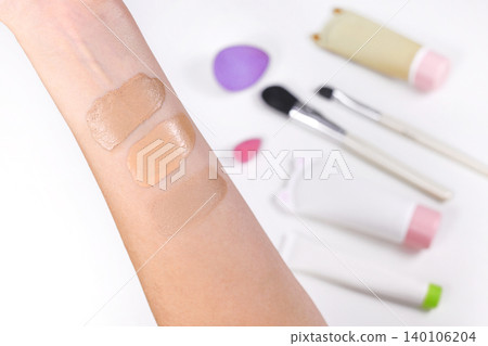 Taking swatches of foundation on lower arm to fight right skin tone shade Taking swatches of foundation on lower arm to fight right skin tone shade 140106204