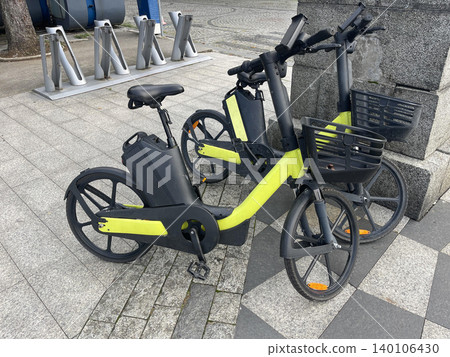 Bicycles parked on the street near a bike-sharing station in a city center during the daytime 140106430