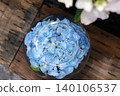 Blue hydrangeas floating in a glass bowl and the scenery of the rainy season. 140106537