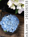 Blue hydrangeas floating in a glass bowl and the scenery of the rainy season. 140106538