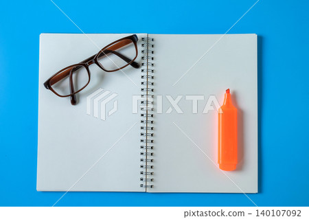 Top view of open student notebook and color marker pen. 140107092