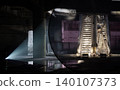 a dramatic intersection of light and shadow transforms a desolate, subterranean ruin into a mysterious artistic stage. On the left, a singular spotlight pierces the darkness, casting a sharp cone of 140107373