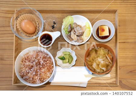 Rice bowl with plenty of bonito flakes and raw egg set meal Rice bowl with plenty of bonito flakes and raw egg set meal 140107552