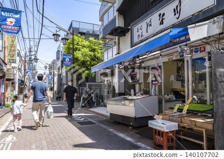 A fish shop and streetscape in front of Nagahara Station, Ota Ward, Tokyo. A fish shop and streetscape in front of Nagahara Station, Ota Ward, Tokyo. 140107702