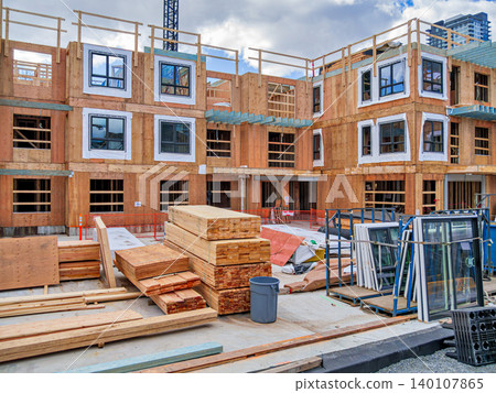 Wooden Frame Building Construction Site Under Cloudy Sky Wooden Frame Building Construction Site Under Cloudy Sky 140107865