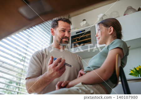 Dad assisting diabetic teen girl with daily insulin treatment routine. Dad assisting diabetic teen girl with daily insulin treatment routine. 140107980