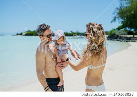 Family enjoying tropical beach vacation at luxury resort. 140108022