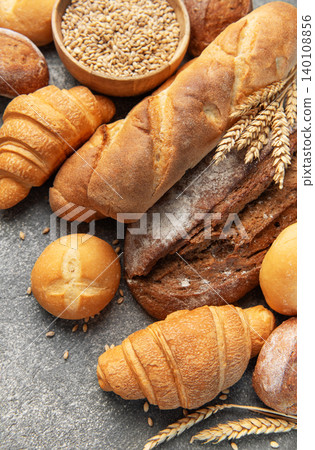 Freshly baked bread and pastries on concrete background Freshly baked bread and pastries on concrete background 140108856
