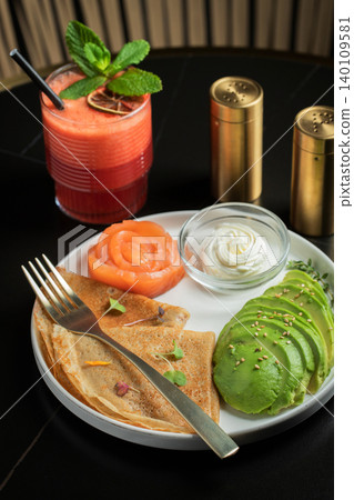 Roasted thin pancakes with smoked salmon and sauce 140109581