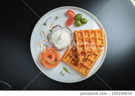 Crunchy waffle fries with sour cream dip served in a basket 140109650