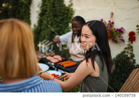 Diverse group of women enjoying outdoor barbecue party Diverse group of women enjoying outdoor barbecue party 140109756