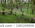 Fun Outdoor Adventure Ropes Course with Rope Net and Tree Stump Obstacles in Forest 140109906