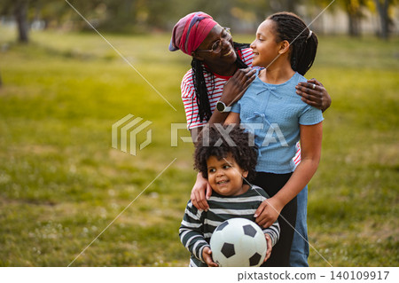 African american family enjoying outdoor activity in park 140109917