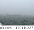 A harbor landscape and the sea shrouded in thick fog. 140110227