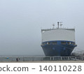 A large ferry seen from the front, and the harbor shrouded in thick fog. 140110228