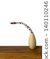 Minimalist ceramic vase with dry eucalyptus leaf branch on wooden shelf. 140110246