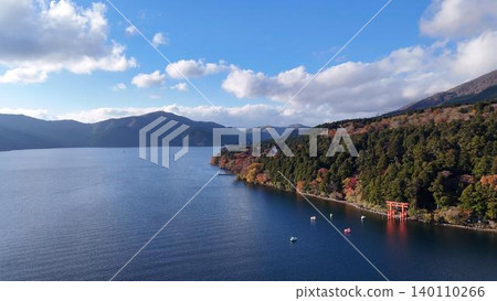 Aerial view of Lake Ashi in autumn, showcasing its beautiful shoreline, and the torii gate of Hakone Shrine. Aerial view of Lake Ashi in autumn, showcasing its beautiful shoreline, and the torii gate of Hakone Shrine. 140110266