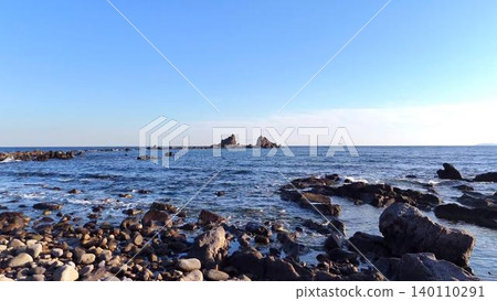 A magnificent view of the famous Mitsuiwa rocks on the Manazuru Peninsula and the blue sky from the rocky shore. A magnificent view of the famous Mitsuiwa rocks on the Manazuru Peninsula and the blue sky from the rocky shore. 140110291