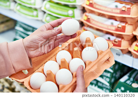 Woman with packing eggs in shop Woman with packing eggs in shop 140110320