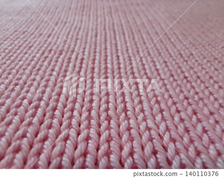 Detailed macro view of pink knitted fabric texture for textile design. 140110376