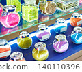 Jars with shiny decorative dyes on exhibition 140110396