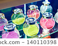 Jars with shiny decorative dyes on exhibition 140110398