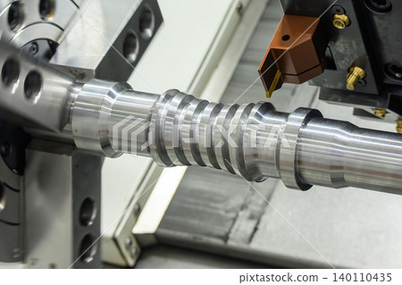 High-precision CNC lathe machine executing a groove cutting process on a metal drive shaft component. High-precision CNC lathe machine executing a groove cutting process on a metal drive shaft component. 140110435