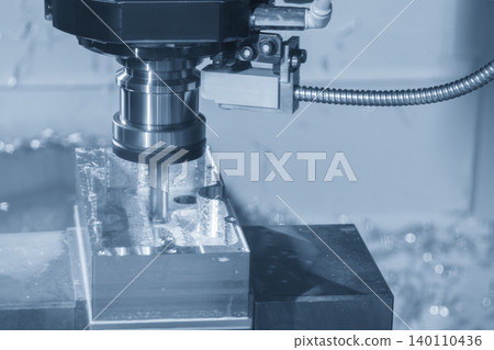 High-precision finish cut of an aluminum case box using a flat nose end mill tool on a CNC milling machine in a light blue scene. High-precision finish cut of an aluminum case box using a flat nose end mill tool on a CNC milling machine in a light blue scene. 140110436
