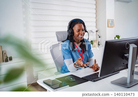 Female nurse providing telemedicine consultation online using computer Female nurse providing telemedicine consultation online using computer 140110473