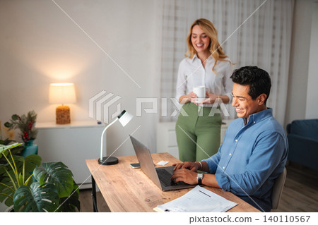 Couple working together remotely at home office 140110567