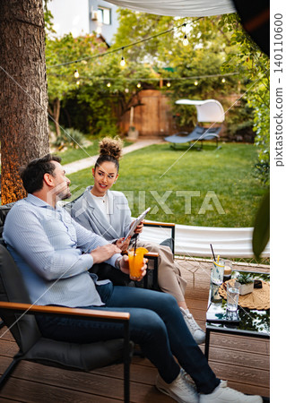 Business colleagues having a relaxed outdoor meeting with digital tablet Business colleagues having a relaxed outdoor meeting with digital tablet 140110600