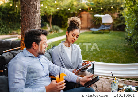 Business partners collaborating outdoors discussing project ideas Business partners collaborating outdoors discussing project ideas 140110601