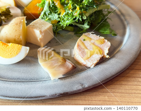 A plate of pickled vegetables and salad. Close-ups of pickled amberjack sashimi and slow-cooked chicken breast. A plate of pickled vegetables and salad. Close-ups of pickled amberjack sashimi and slow-cooked chicken breast. 140110770
