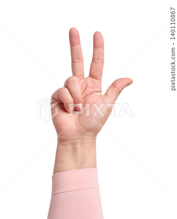 A woman's hand in a pink sleeve shows a gesture with three fingers raised on 140110867