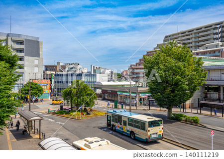 A view of the station building and rotary in front of Hanakoganei Station on the Seibu Shinjuku Line, with a clear blue sky above. A view of the station building and rotary in front of Hanakoganei Station on the Seibu Shinjuku Line, with a clear blue sky above. 140111219