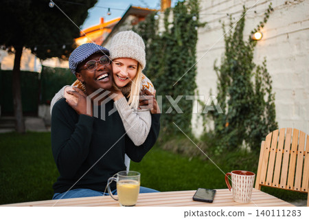Happy multiracial couple embracing outdoors enjoying autumn day Happy multiracial couple embracing outdoors enjoying autumn day 140111283