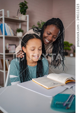 Mother and daughter learning together during homeschooling Mother and daughter learning together during homeschooling 140111323