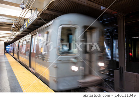 New york, usa august 21,2024. Subway train arriving or departing a new york city station platform, creating motion blur representing urban speed and transport New york, usa august 21,2024. Subway train arriving or departing a new york city station platform, creating motion blur representing urban speed and transport 140111349