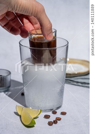 Coffee bomb with sparkling water and espresso shot, trendy summer coffee drink Coffee bomb with sparkling water and espresso shot, trendy summer coffee drink 140111889