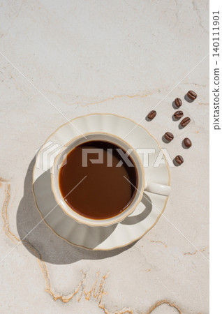Freshly brewed espresso coffee in a cup on a beige marble background 140111901
