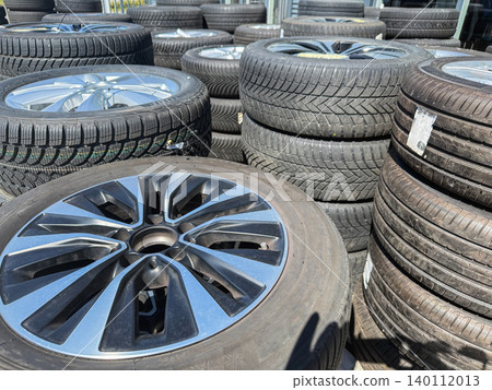Stack of used vehicle tires and alloy wheels Stack of used vehicle tires and alloy wheels 140112013
